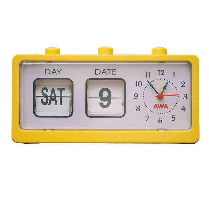 Yellow retro alarm clock on a wicker table