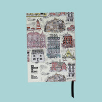 Notebook with illustrated cityscape design on a white background