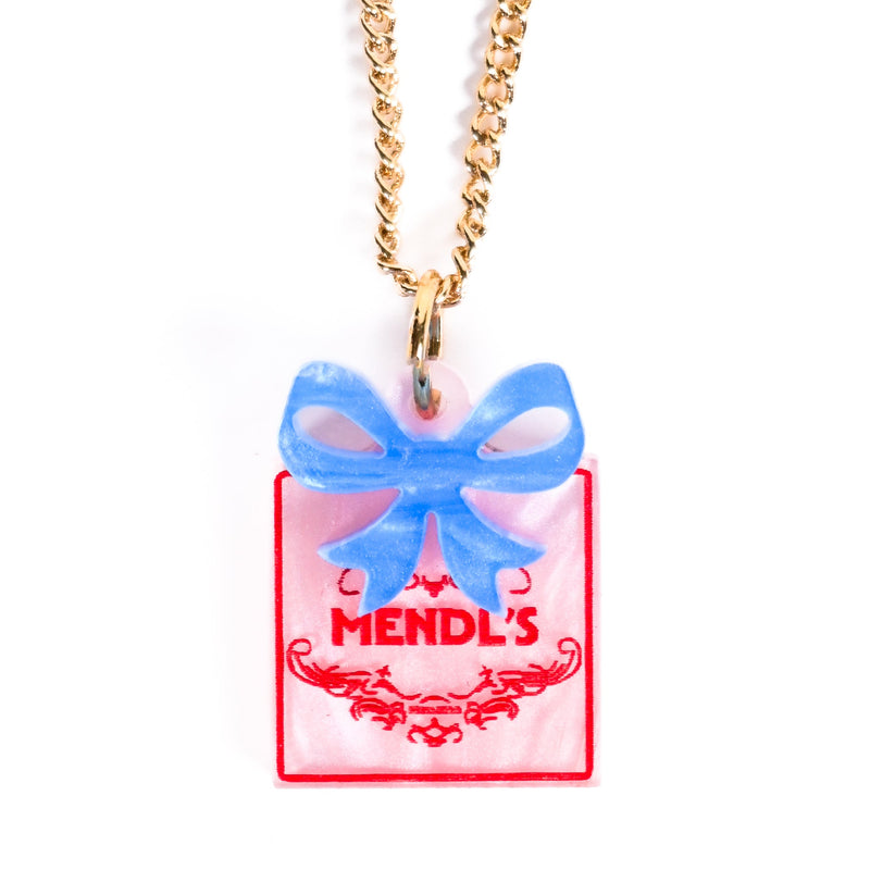 Necklace with a pink box pendant with a blue bow and 'Mendl's' text on a white background