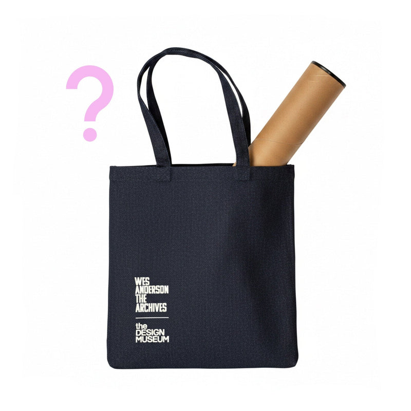 Black tote bag with a cylindrical object inside, featuring 'Wes Anderson The Archives' and 'The Design Museum' text.