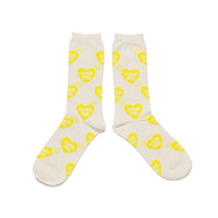 White socks with yellow heart patterns on a white background