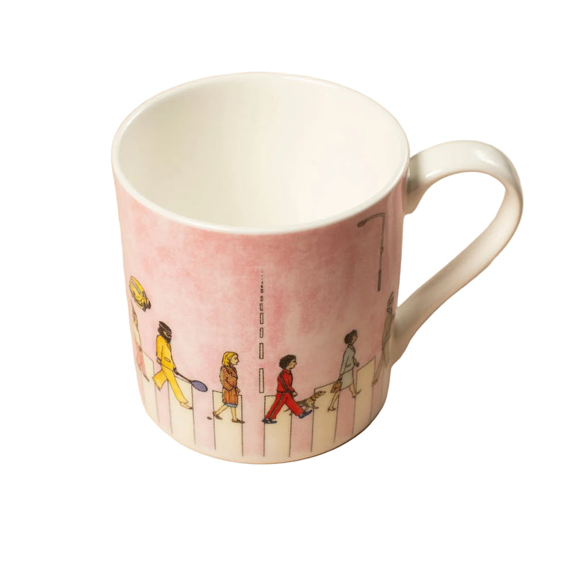 Pink mug with colorful illustrations of people walking on a crossing against a white background.