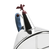 Close up of a stainless steel kettle with a brown bird-shaped spout and blue handle on a white background. 