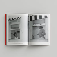 Open book showing black and white photos of a woman in a kitchen.