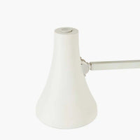 White adjustable desk lamp on a white background