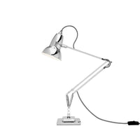 Chrome desk lamp with adjustable arm on a white background