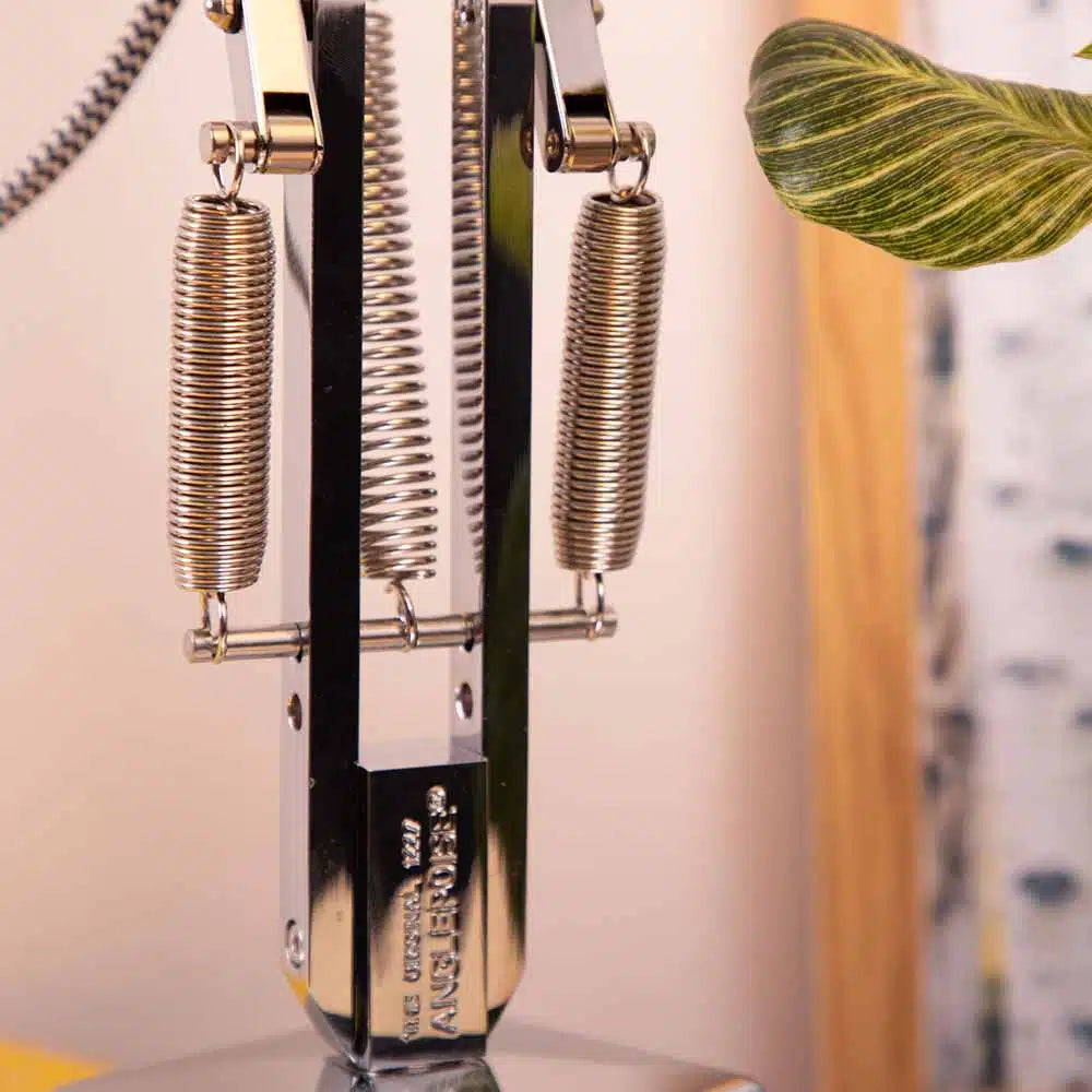Close up of spring mechanism of adjustable silver desk lamp