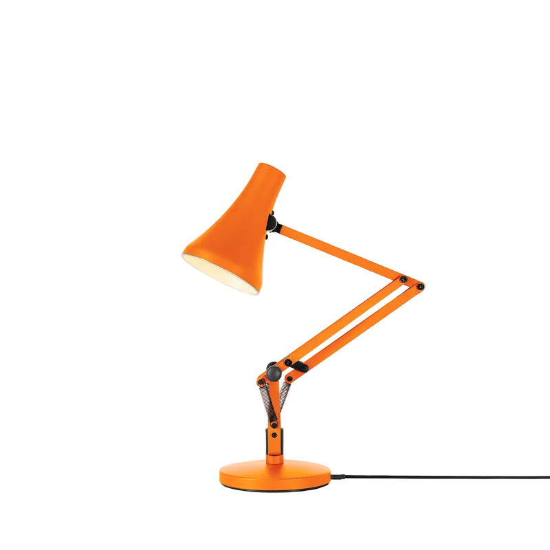 Orange desk lamp with adjustable arm on a white background