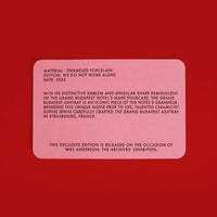 Pink rectangular certificate of authenticity on a red background