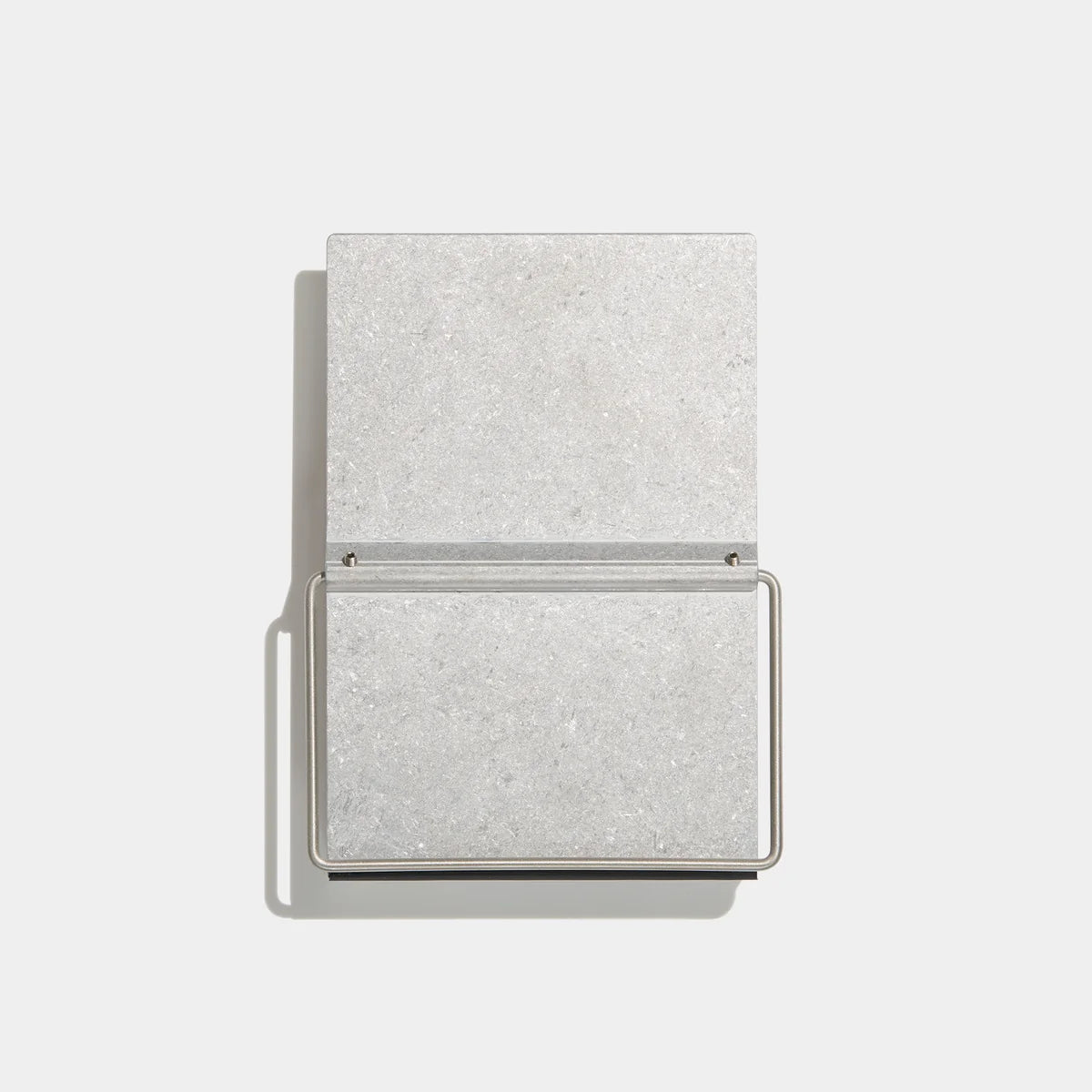 A minimalist rectangular metal bookstand shown open against a clean white background.