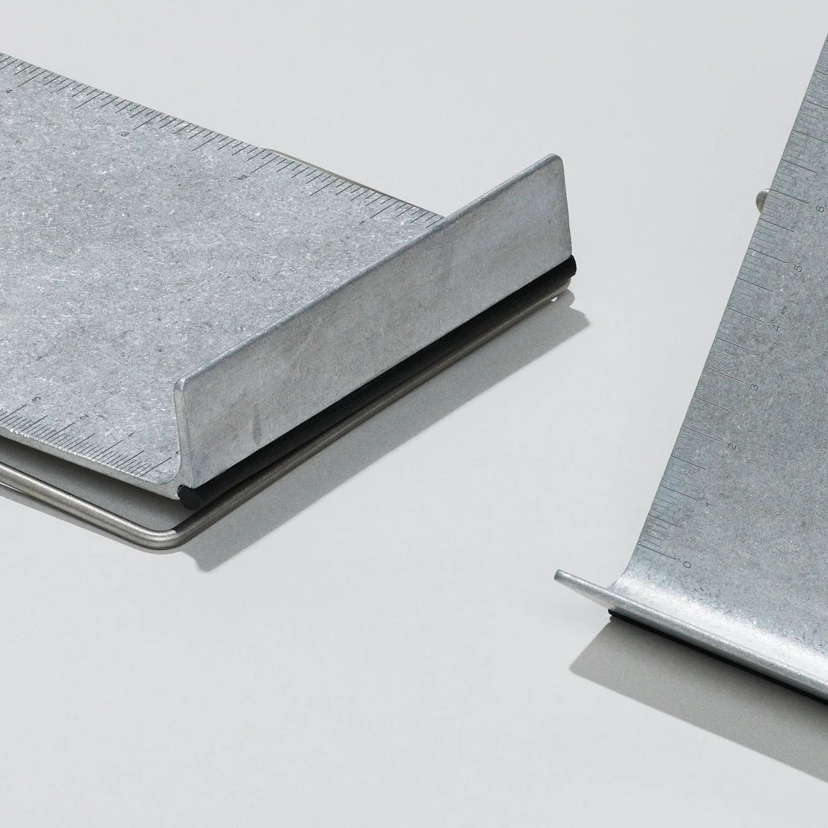Two metal bookstands shown on a clean light gray background.