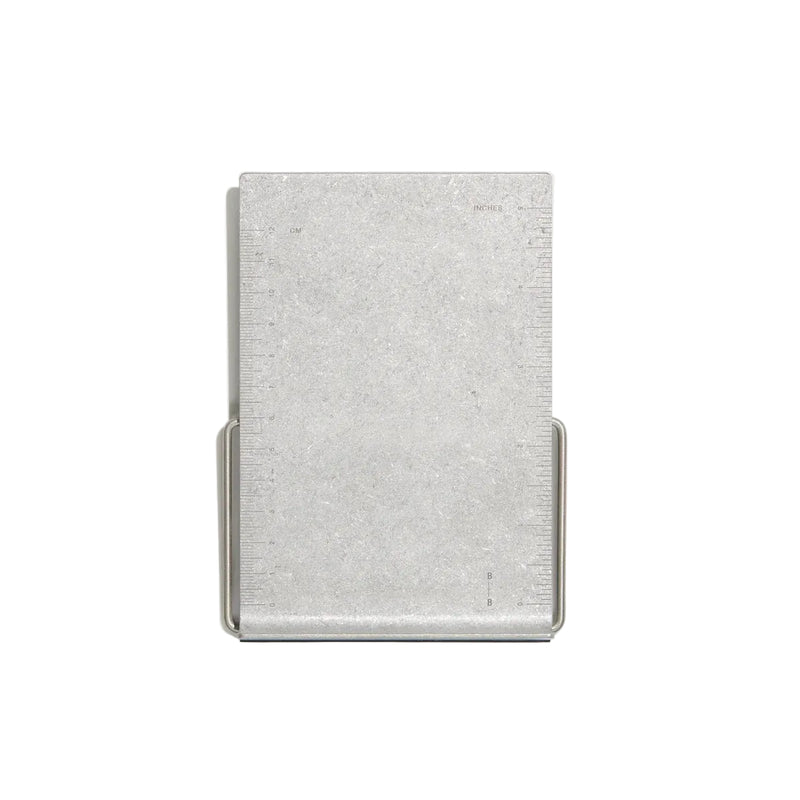 A minimalist silver metal bookstand, shown on a light gray background.