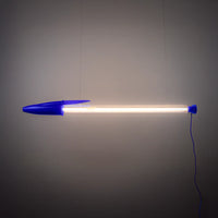 Blue BIC pen lamp hung against a grey wall. 