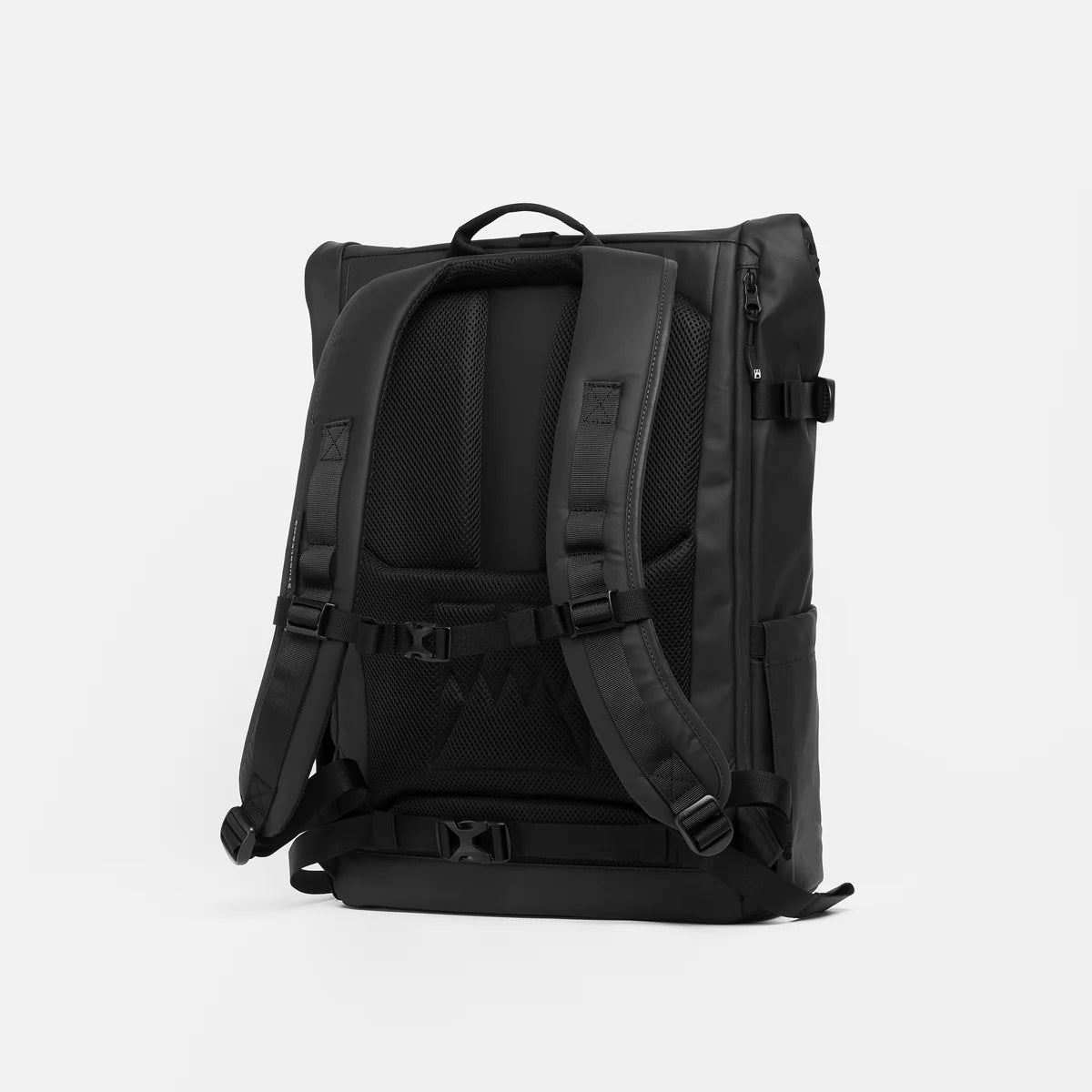 Back of a black backpack on a light gray background