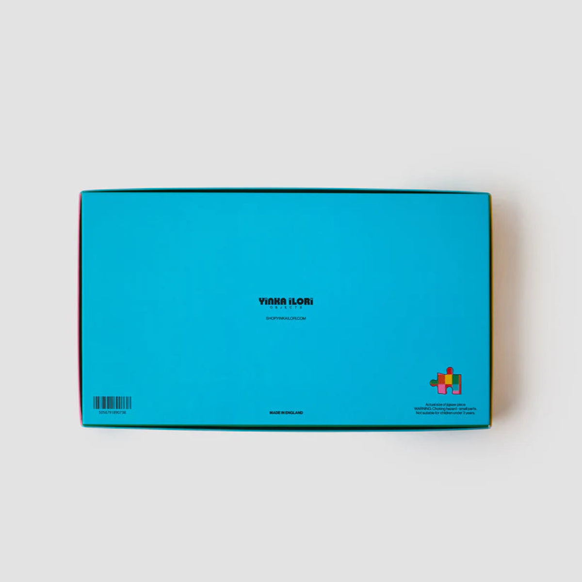 The back of a blue jigsaw box with branding on a light gray background