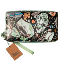 An abstract patterned leather pouch with a tag on a white background