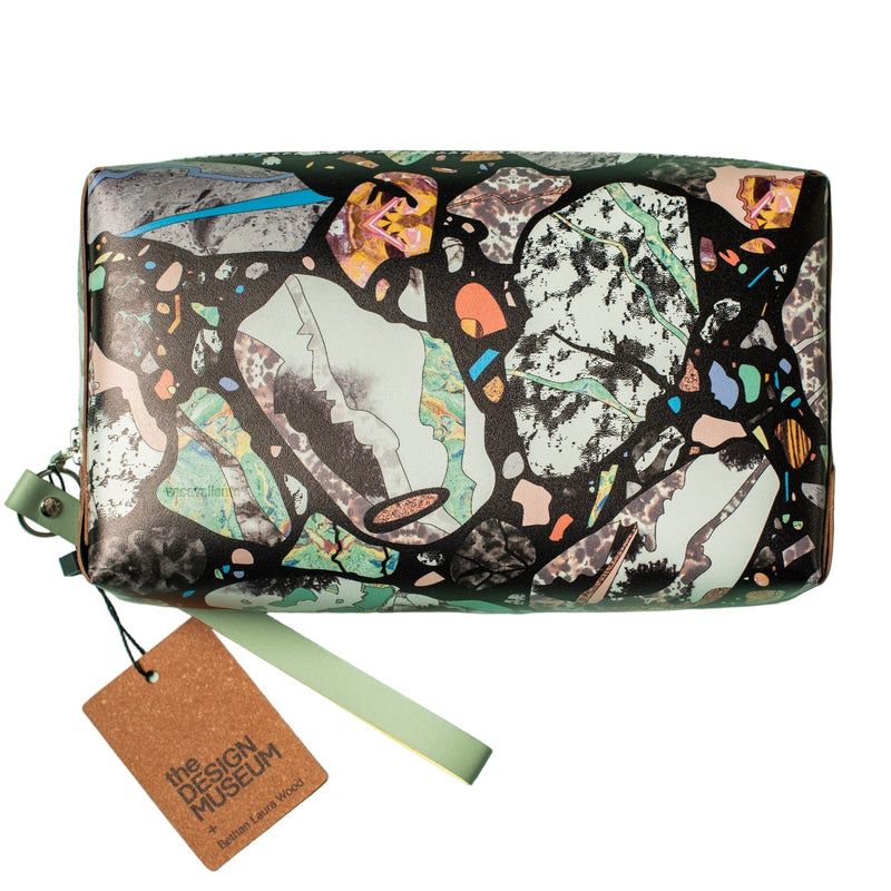 An abstract patterned leather pouch with a tag on a white background
