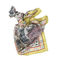 Colorful patterned scarf with a cityscape design on a white background