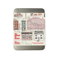 Metal jigsaw puzzle tin with architectural illlustrations and text on a white background