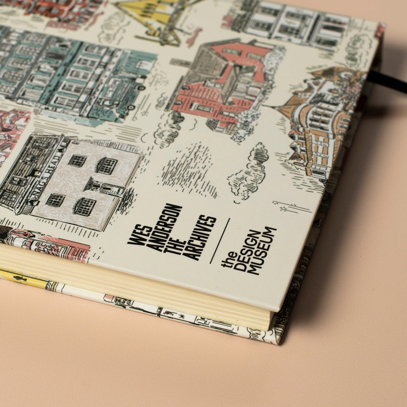 The corner of a notebook with architectural illustrations on a beige background
