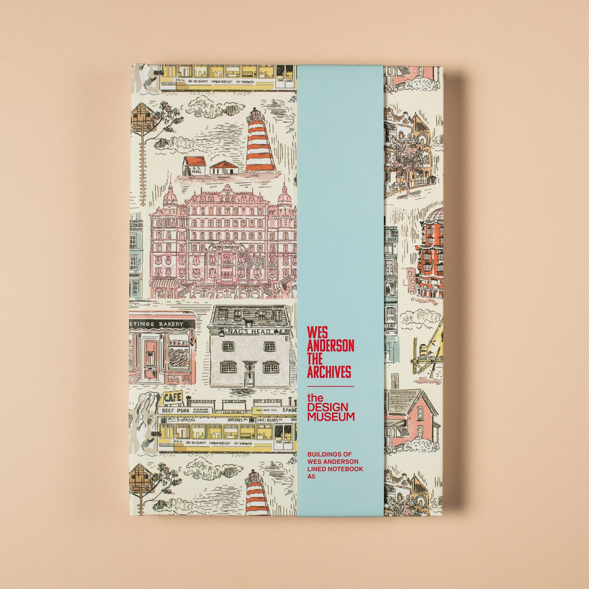 Notebook with coloufrul illustrations of buildings and blue packaging sleeve on a beige background