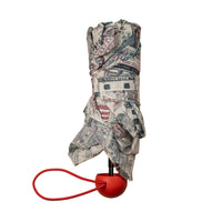Folded umbrella with a red handle on a white background