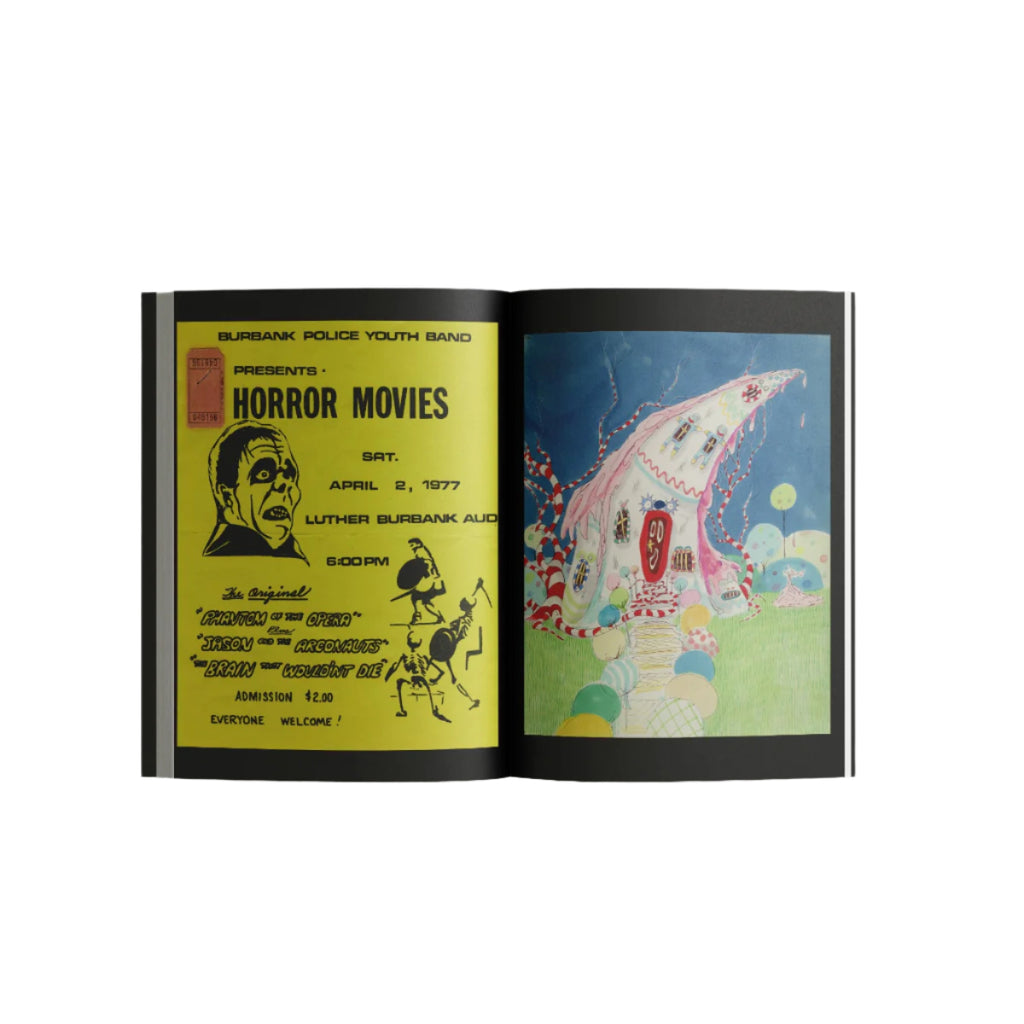 Tim Burton Exhibition catalogue open page picture with a yellow poster of a horror movie, and candy house illustration.