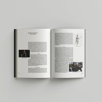 Open page of Tim Burton 'Designing Worlds' catalogue featuring text with small images of cat woman costume designs.