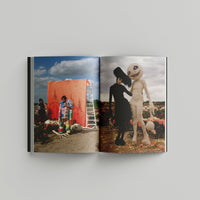 Open page of Tim Burton 'Designing Worlds' catalogue featuring photos from a colourful and macabre Tim Walker photoshoot.