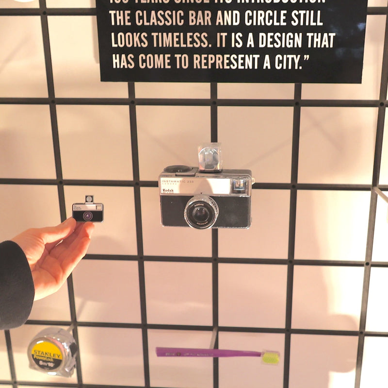 Vintage camera on a grid wall with text above