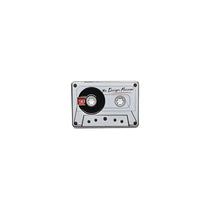 Cassette tape pin badge on a white background