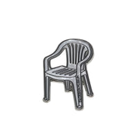 Metallic garden chair-shaped magnet on a white background