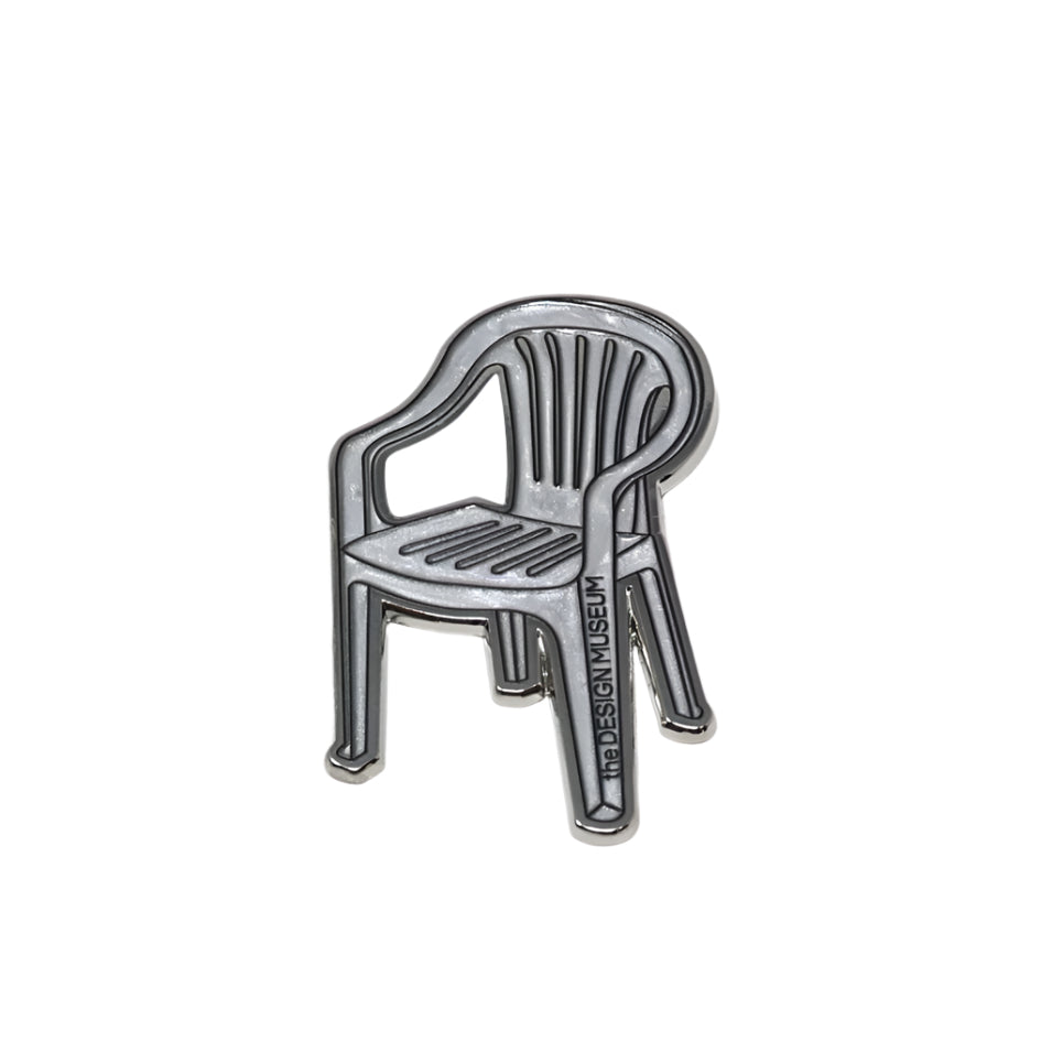 Metallic garden chair-shaped magnet on a white background