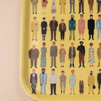 Illustrations of various Wes Anderson charactrers on a yellow tray.