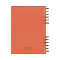 The back of a red notebook with green spiral binding on a white background