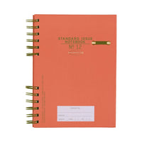 Red notebook with green spiral binding on a white background