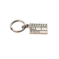 Silver clapperboard keychain with 'Wes Anderson: The Archives' logo on a white background