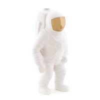 White ceramic vase shaped like an astronaut on a white background