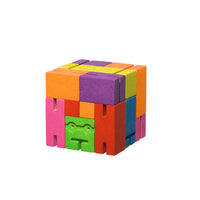 A colourful wooden toy robot in the shape of a cube.