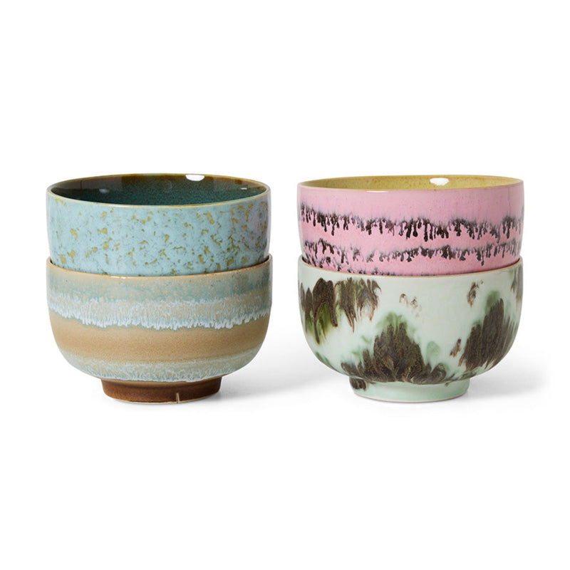 A set of 4 colourful abstract hand-painted ceramic noodle bowls on a white background. 