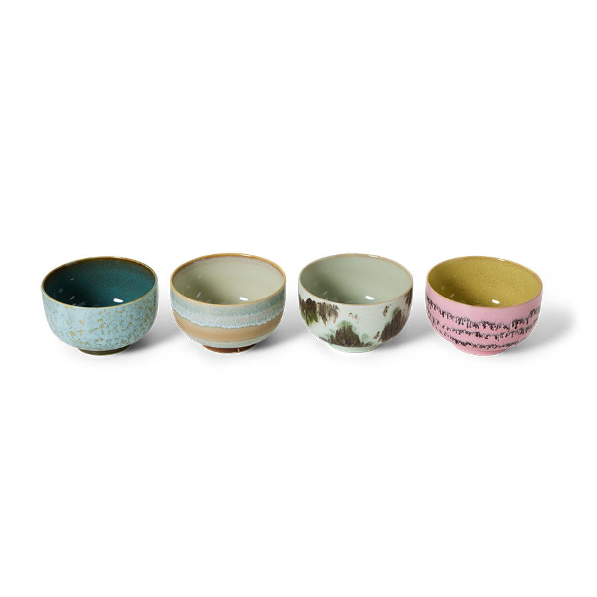A set of 4 colourful abstract hand-painted ceramic noodle bowls in a row on a white background. 