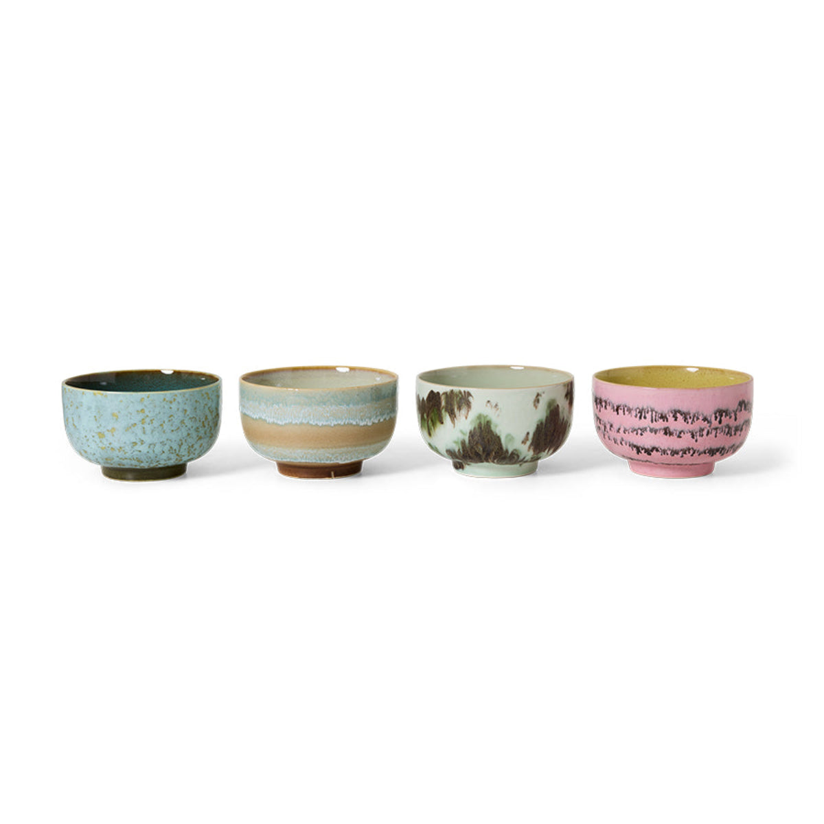 A set of 4 colourful abstract hand-painted ceramic noodle bowls in a row on a white background. 