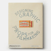 Book cover of 'Designing Graphic Props for Filmmaking' with blue text on a beige background
