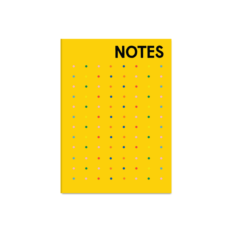 A yellow notebook with the word 'NOTES' in bold black letters at the top and a grid of small multicolored dots across the front
