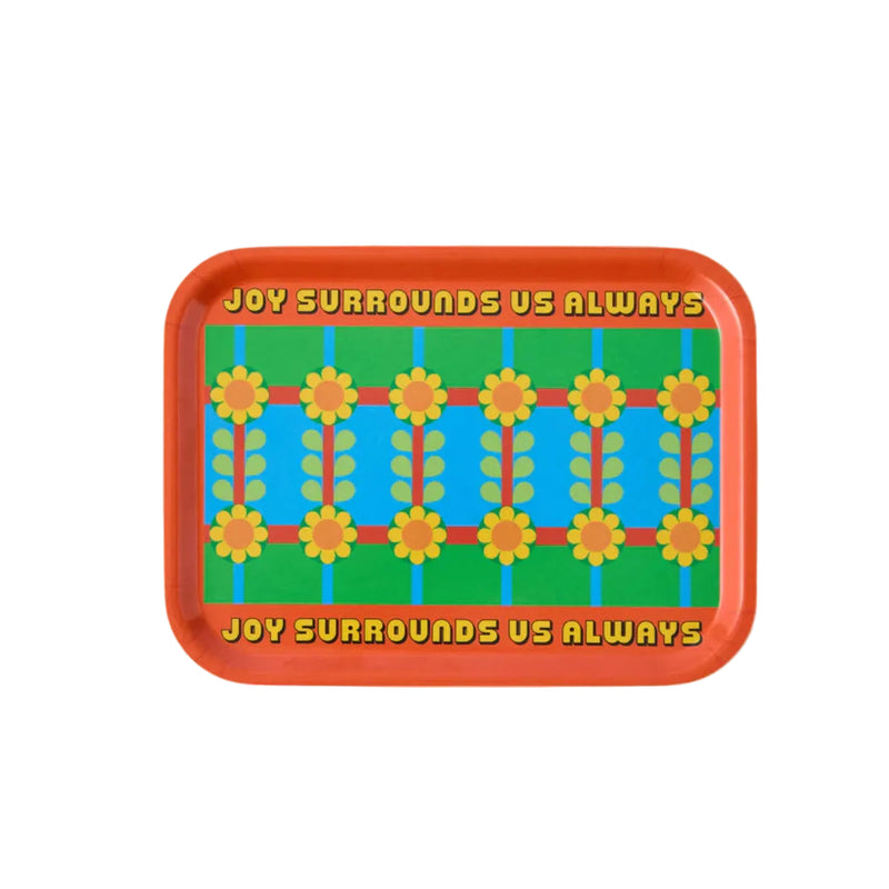 Decorative tray with colourful floral pattern and text 'Joy Surrounds Us Always' on a light gray background