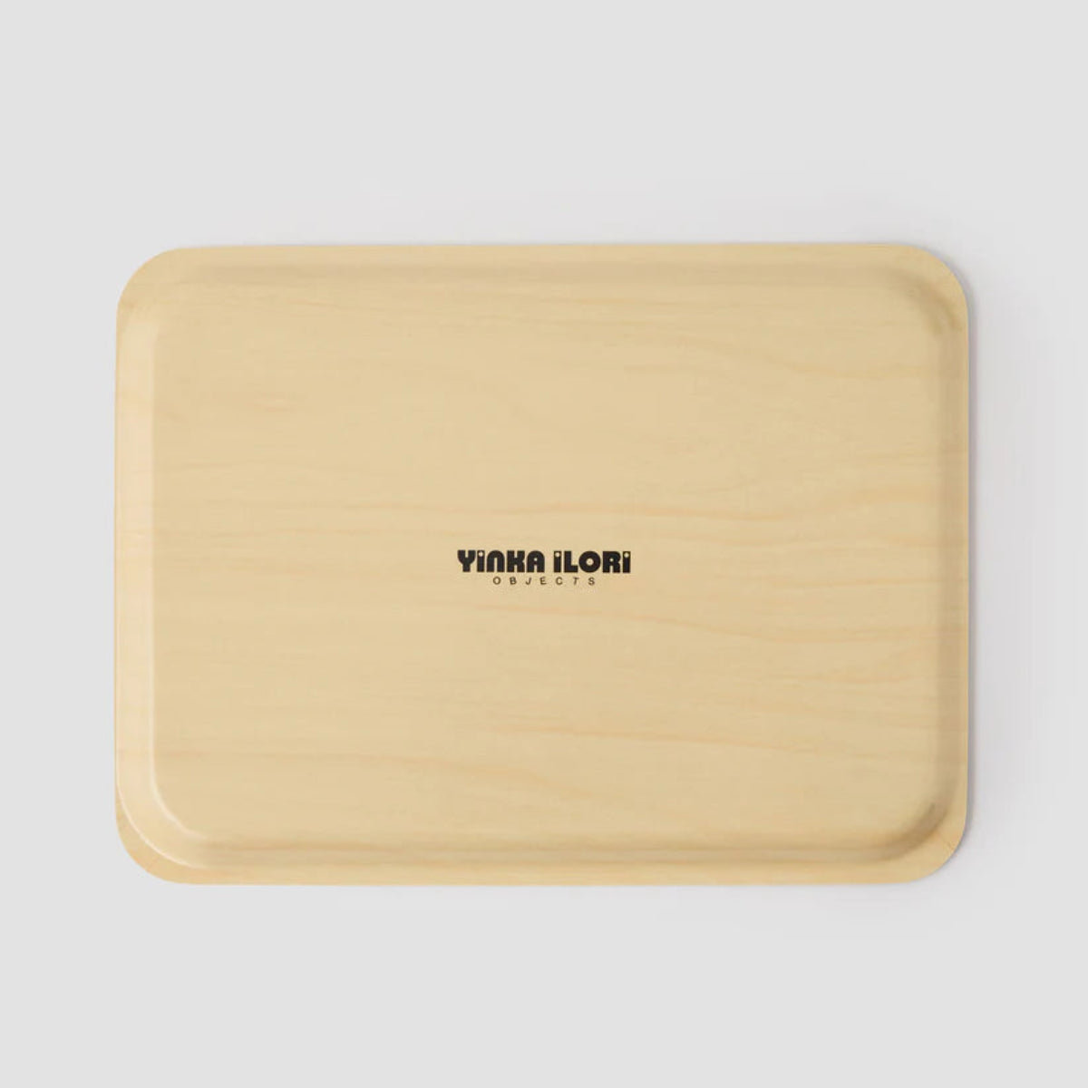 The back of a beige tray with 'YINKA ILORI' branding on a light gray background