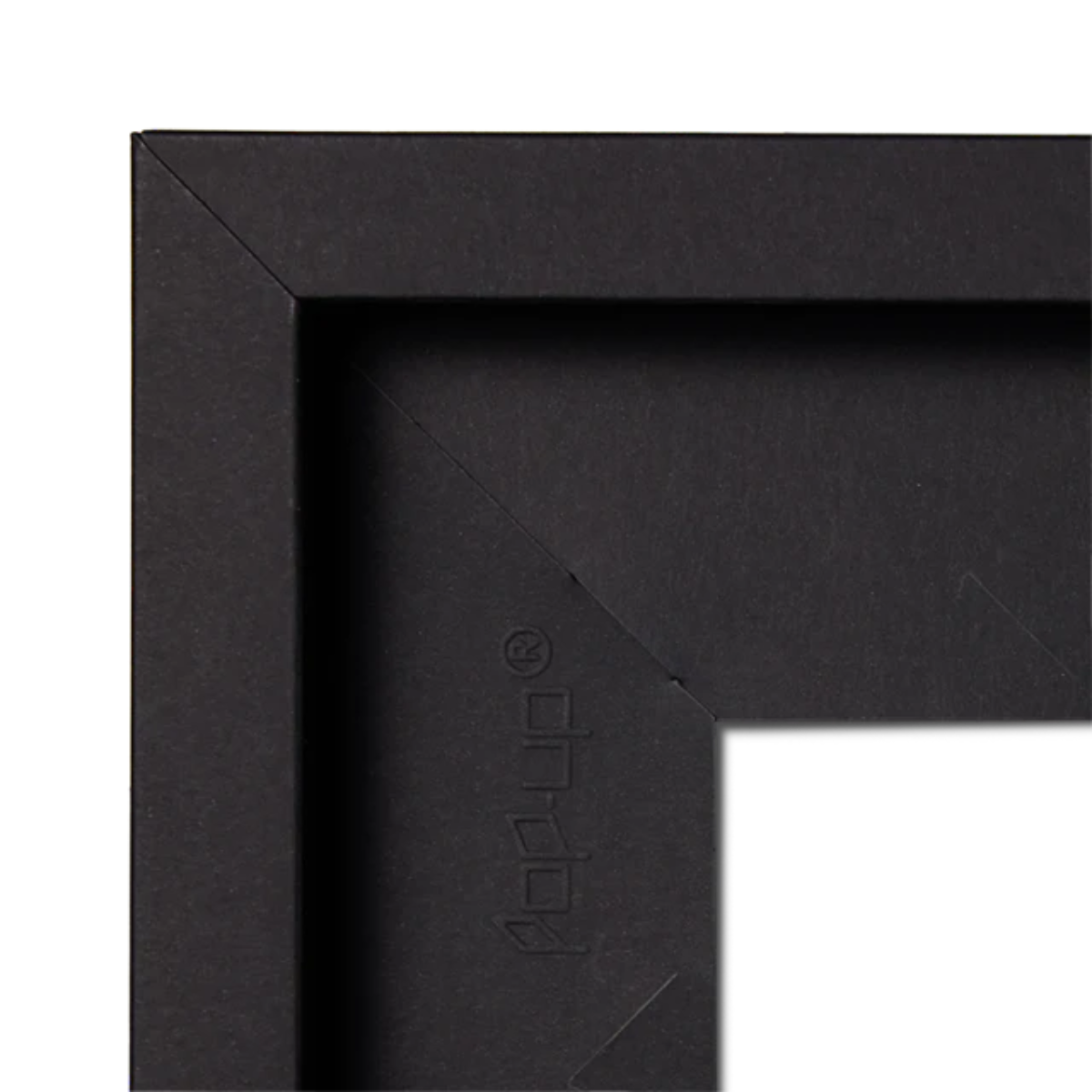 Close-up of a black picture frame corner with 'pop-up' brand logo.