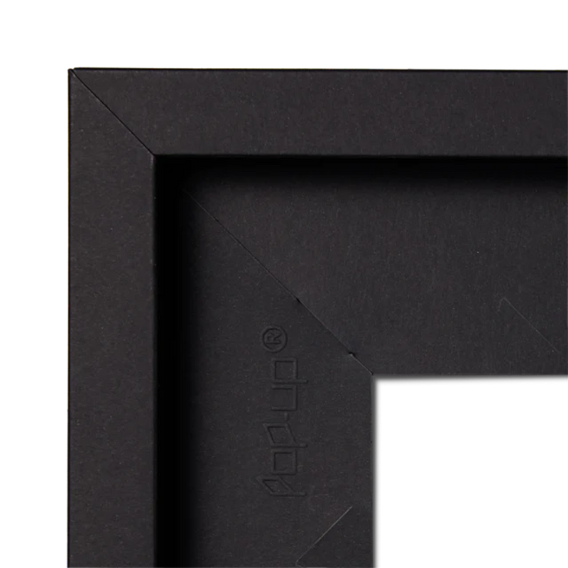Close-up of a black picture frame corner with 'pop-up' brand logo.