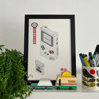 A framed vintage Japanese inspired poster featuring a Gameboy console and its cartridges, printed in grayscale with red accents.