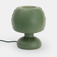 A dark green minimal shaped lamp on a white background.